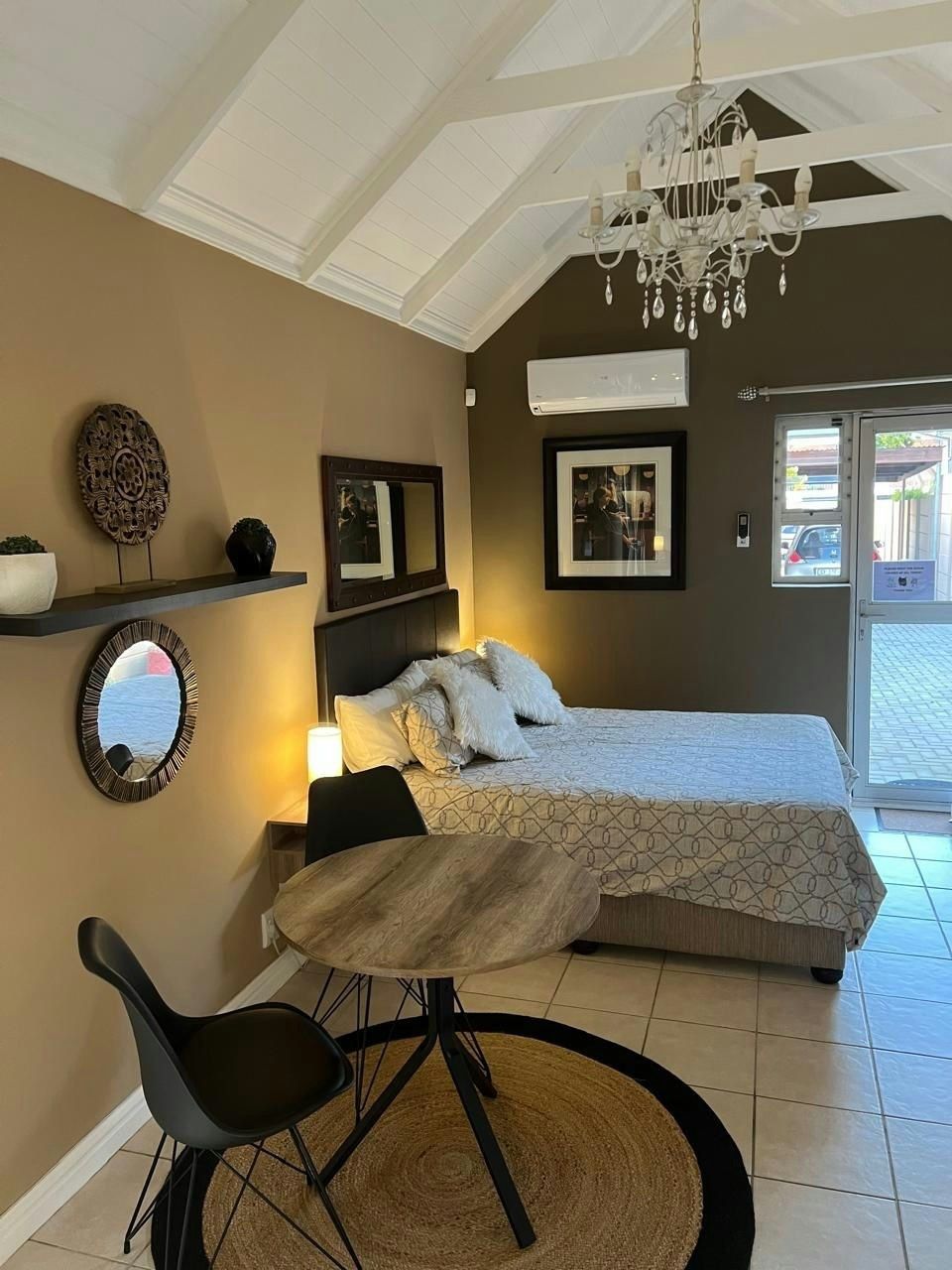 Bedroom with queen bed and bistro table